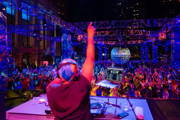 A DJ performs for a crowd.